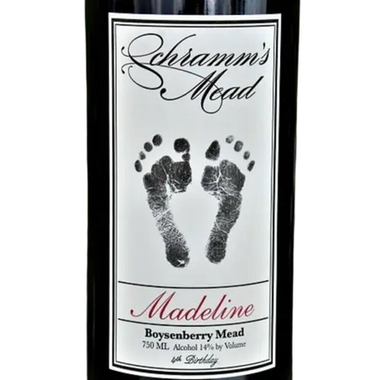 Bottle of Schramm's Mead with a label featuring footprints and text.