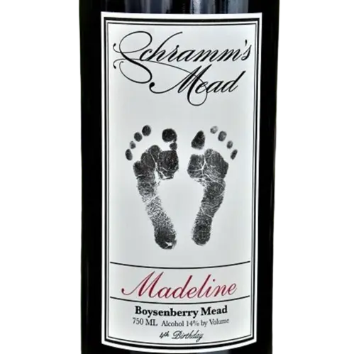 Bottle of Schramm's Mead with a label featuring footprints and text.