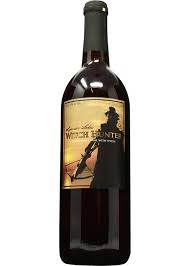 Wine bottle with a label featuring a silhouette of a person on horseback.
